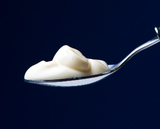 Spoon of yogurt with cultures